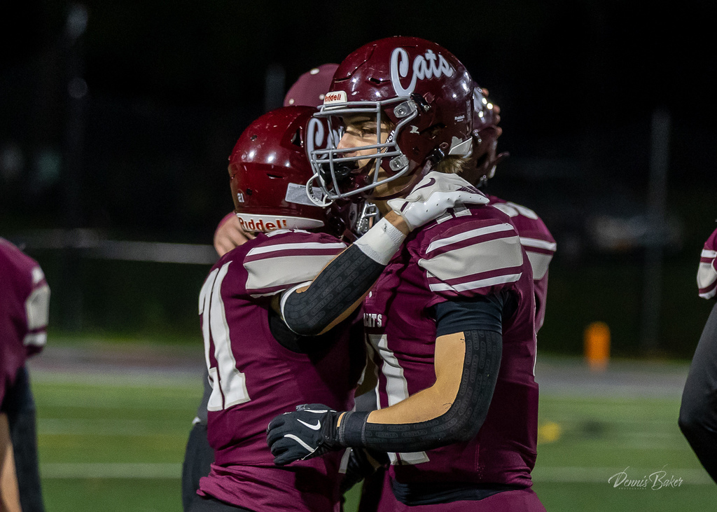 Football players on the field celebrating a win