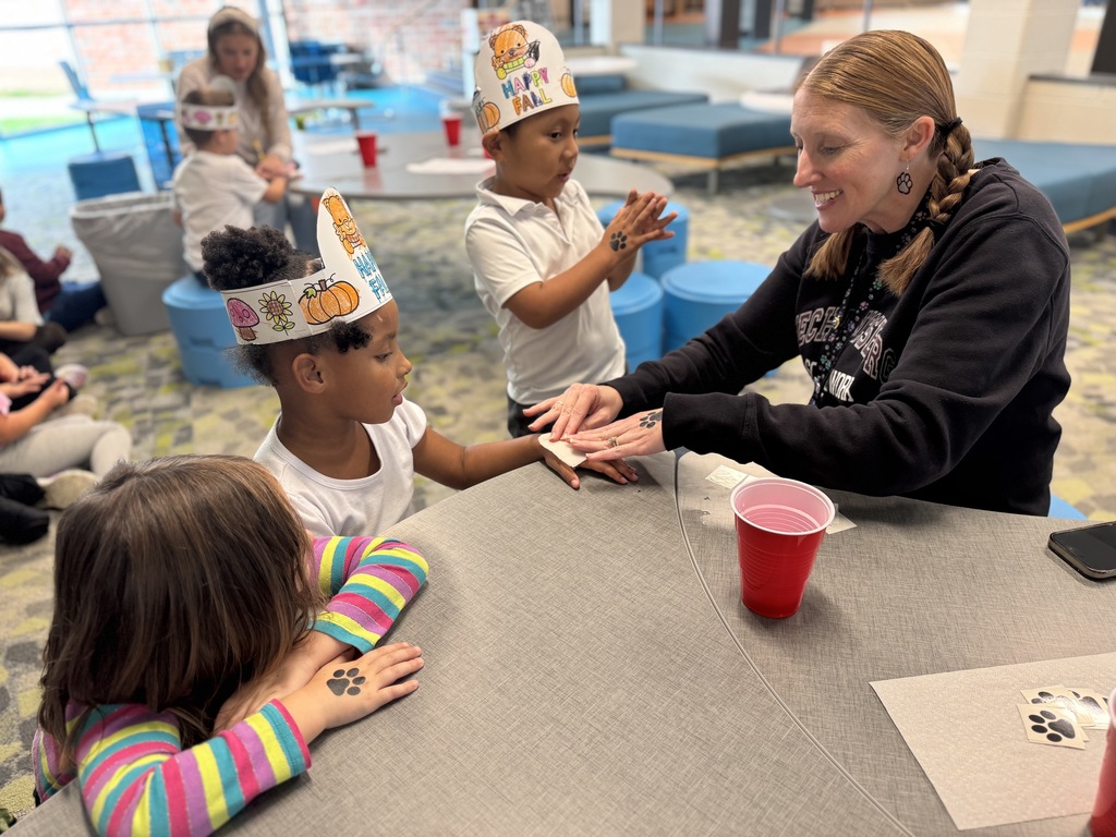 A student getting a temporary tattoo of a paw print.