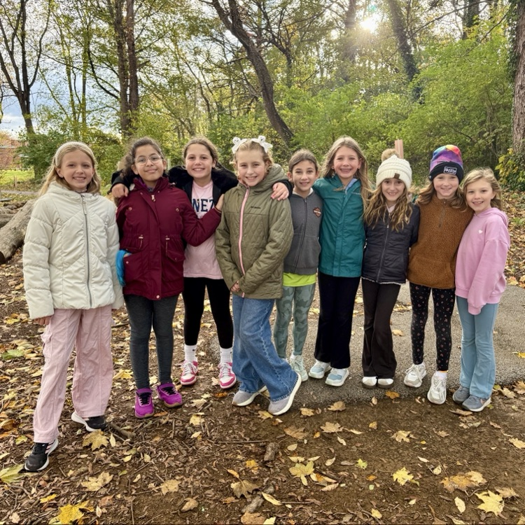 A group of elementary students in hats and jackets enjoying the fall weather