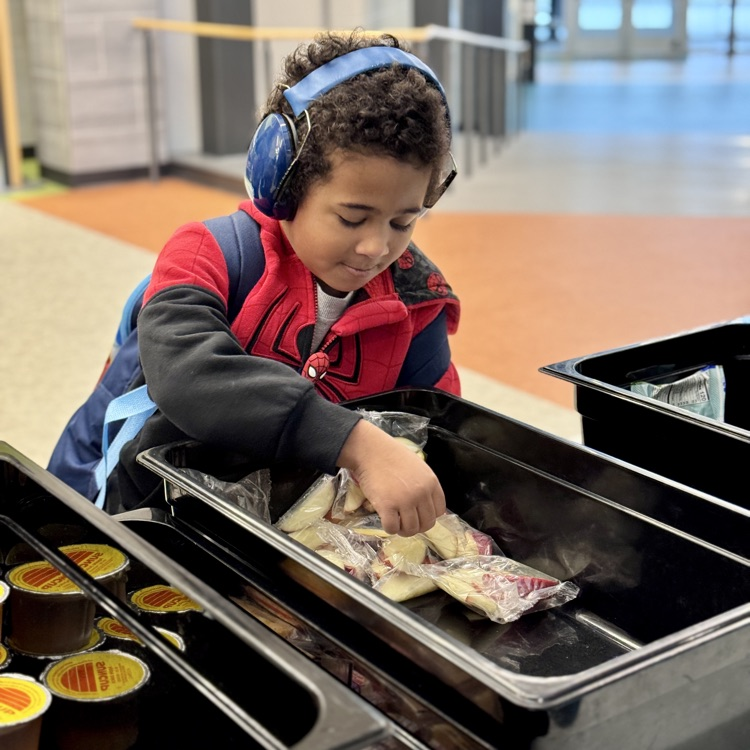 a young boy picks breakfast items