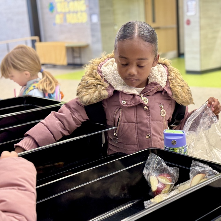 a young girl picks breakfast items
