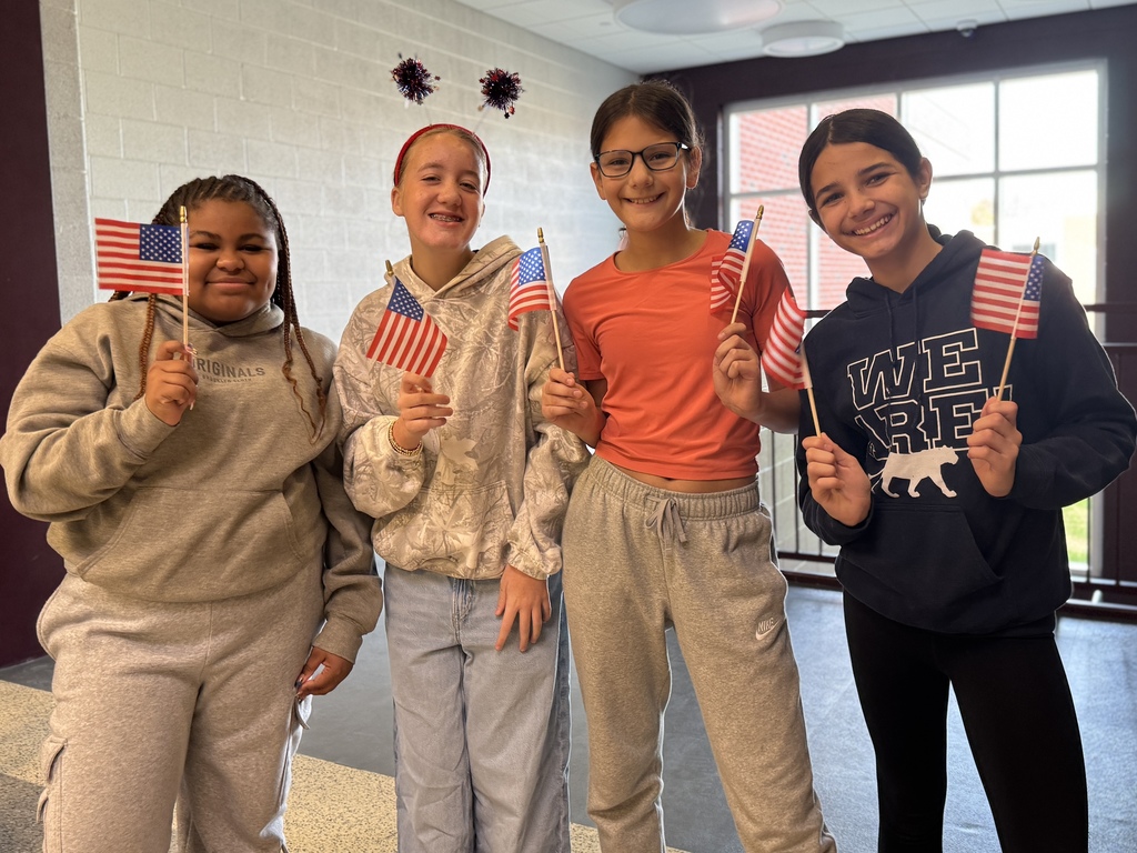 Students waving flags in appreciation for Veterans.