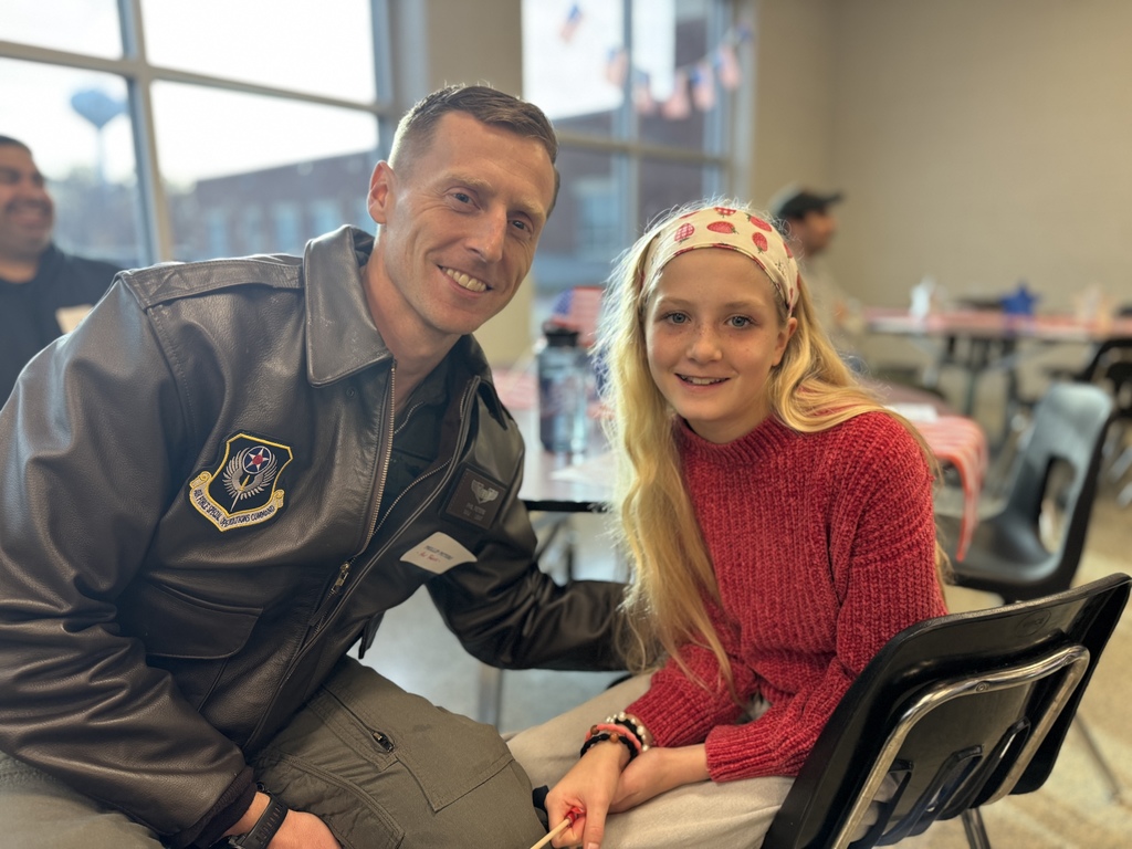 A student sitting with a family member who is a veteran.