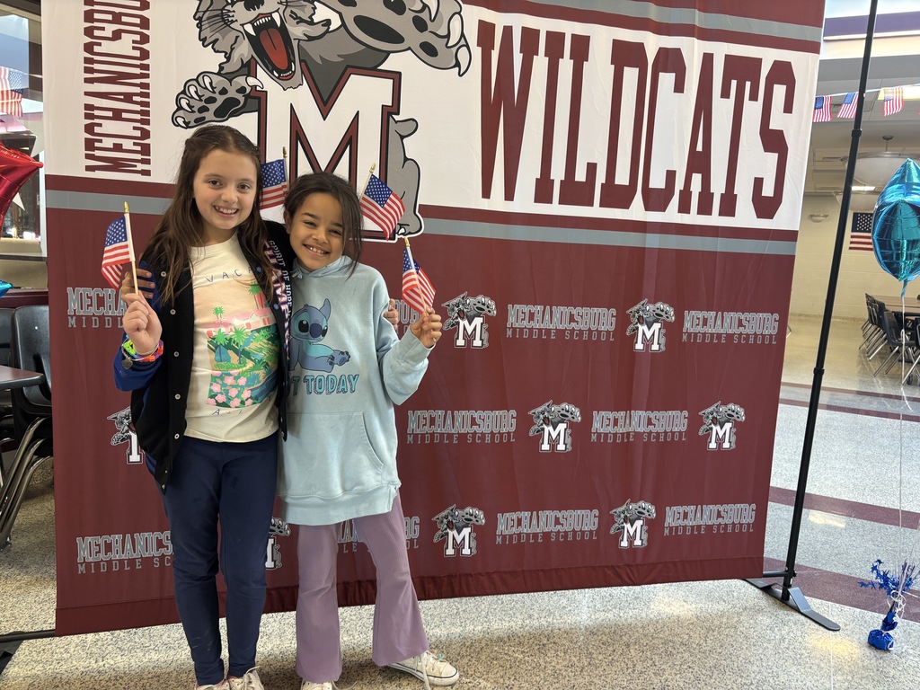 Students with flags, ready to wave at veterans
