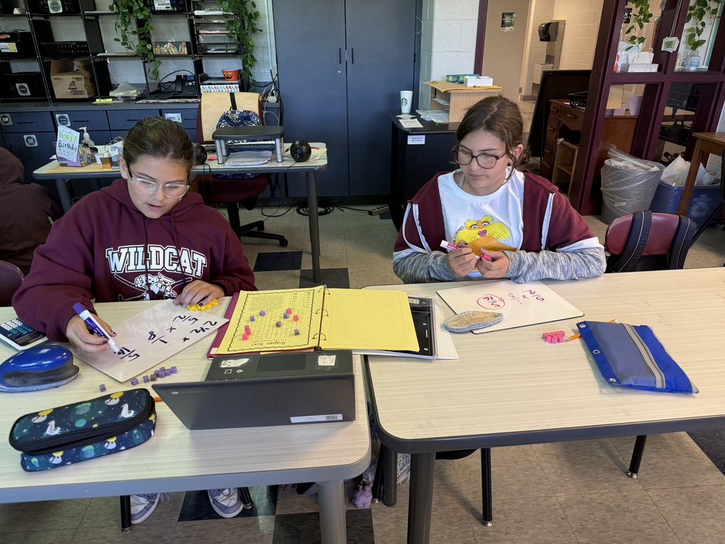 Two students playing a game in math to help learn fractions.