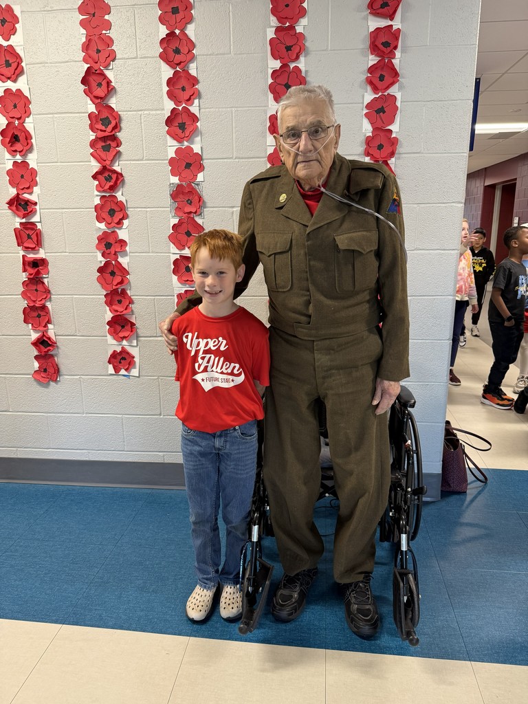A student with a veteran in uniform.