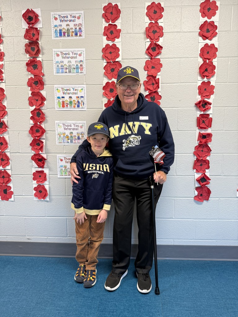 A student and veteran wearing Navy sweatshirts
