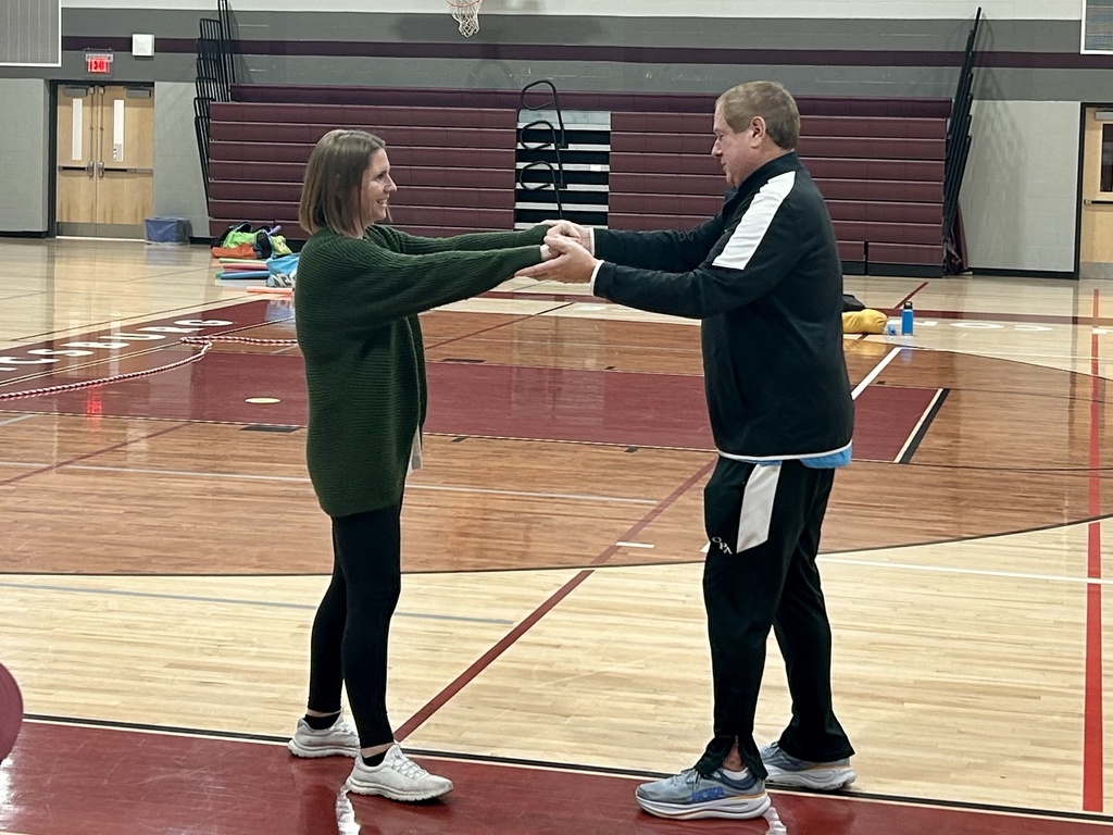 A gentleman working with a coach on a team building lesson.