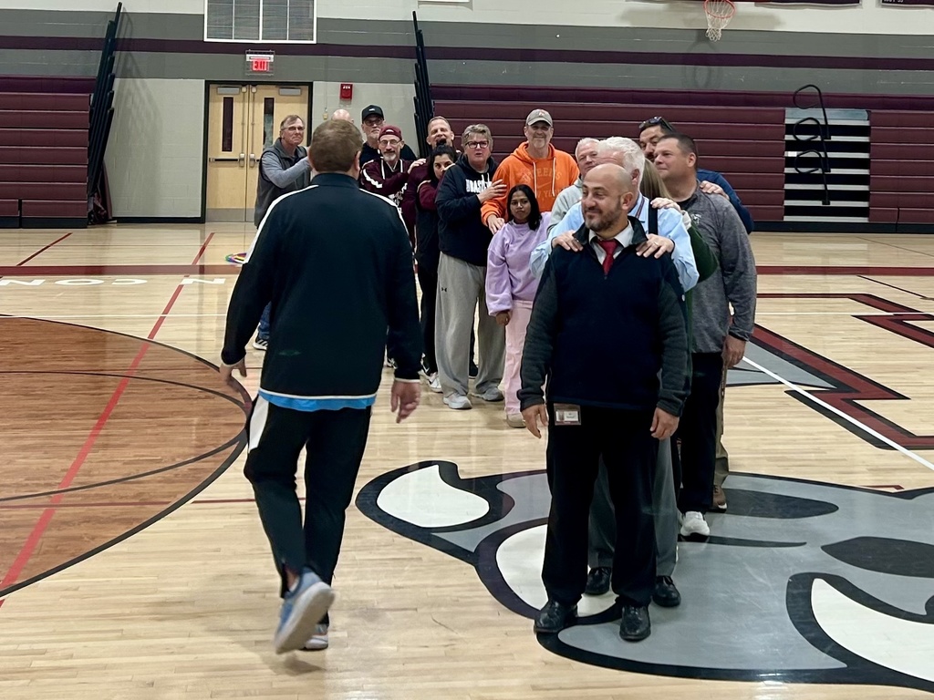 A gentleman working with coaches on a team building lesson.