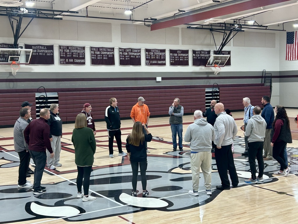 A gentleman working with coaches on a team building lesson.