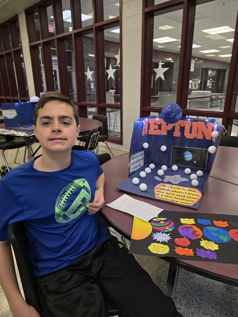 A student showing his solar system display.