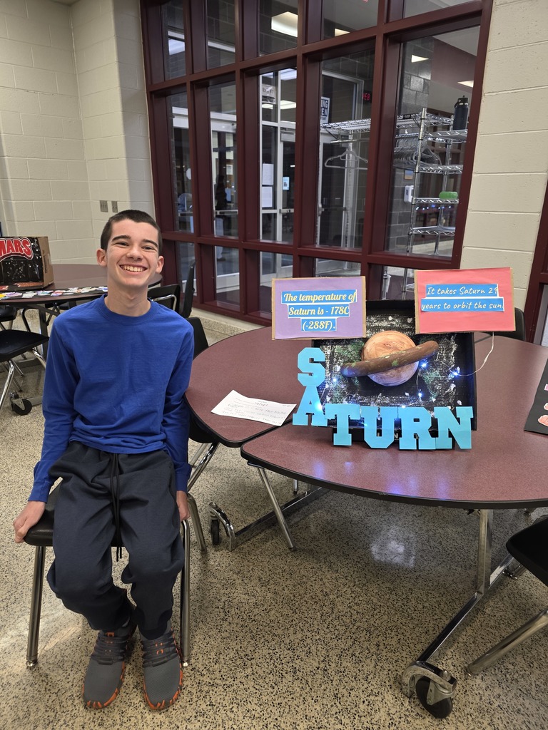 A student showing his solar system display.