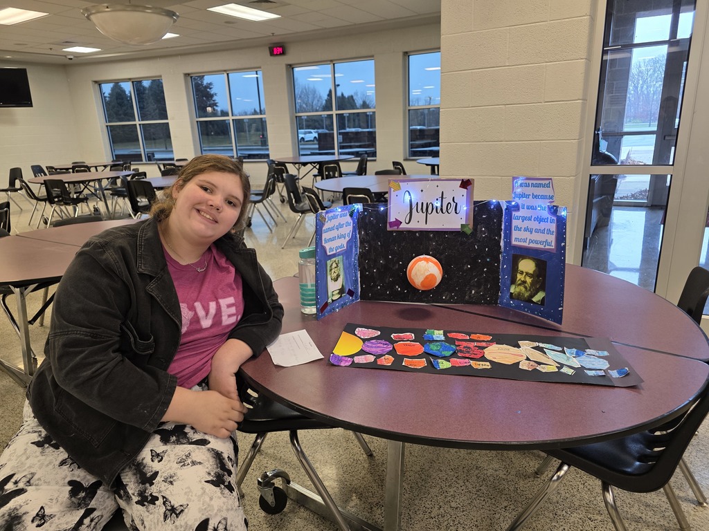 A student showing a solar system display.