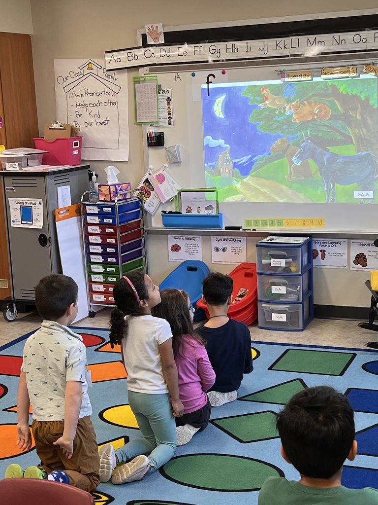 A group of young students watching a folktale story.