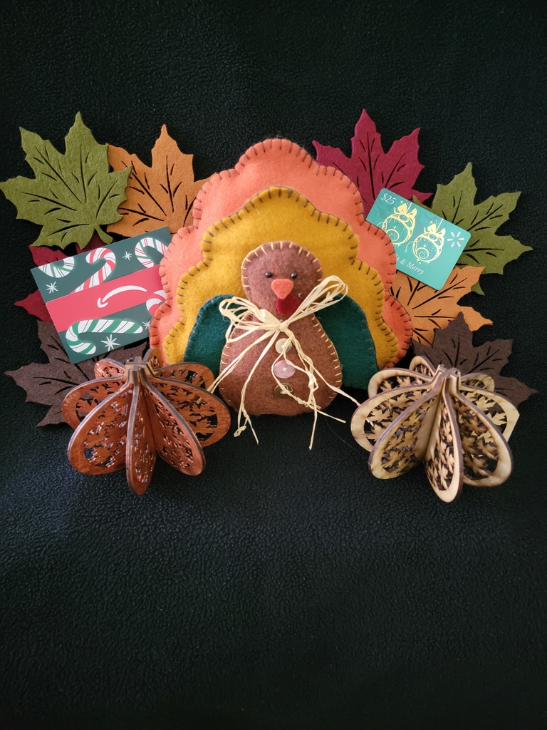 A fall craft display holding gift cards.