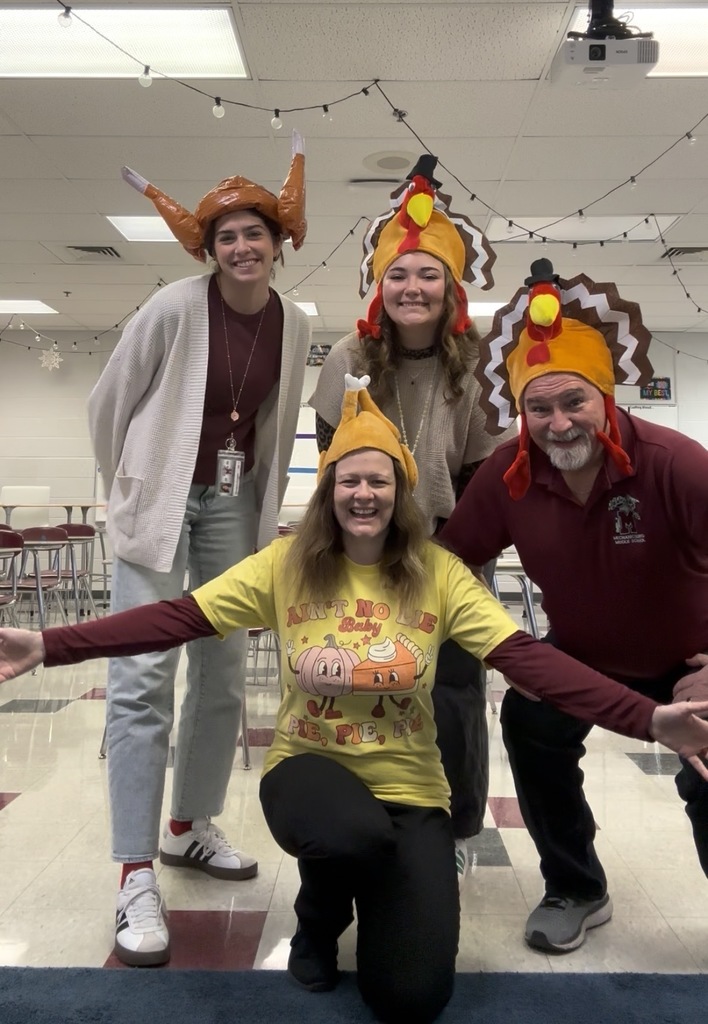 Educators wearing turkey hats.