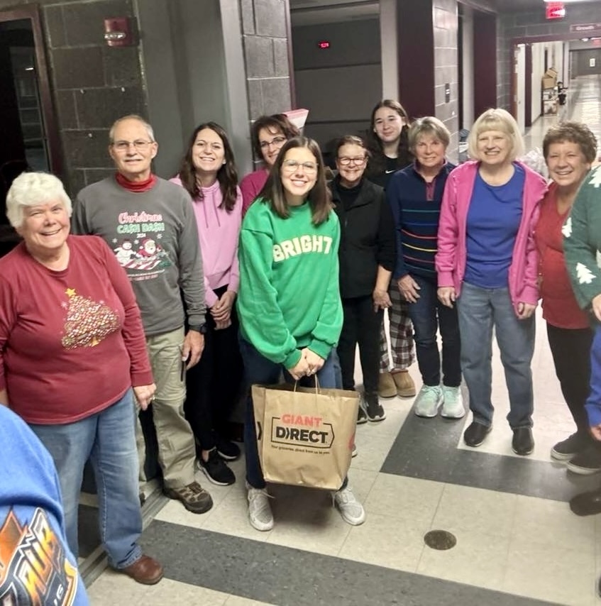 A group of volunteers standing in a hallway.