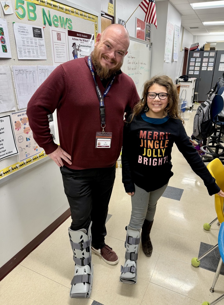 A staff member and student wearing matching "boots"