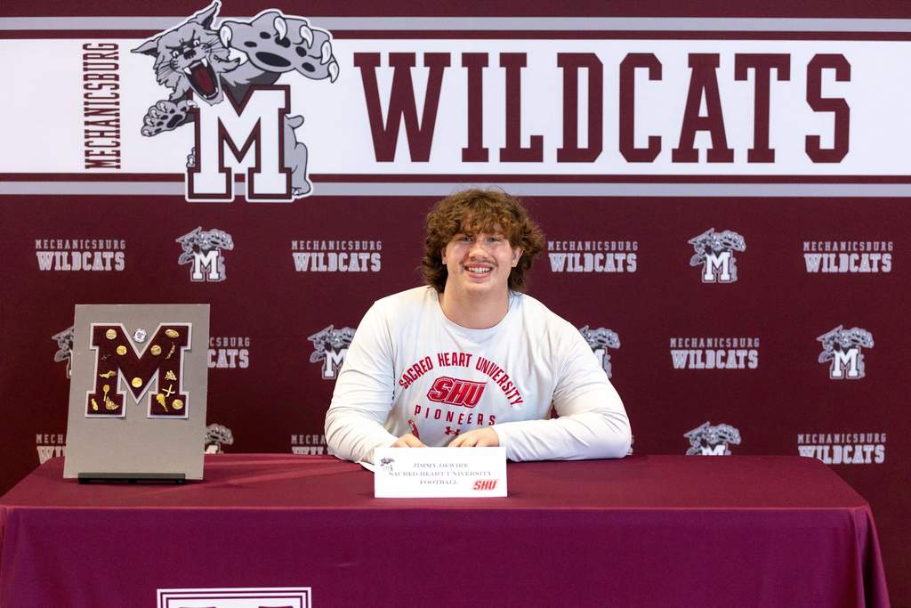 Football player signing his letter of intent.