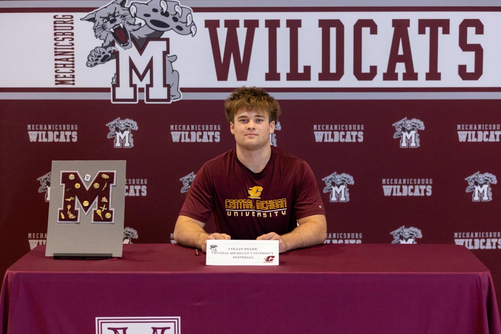 Football player signing his letter of intent.