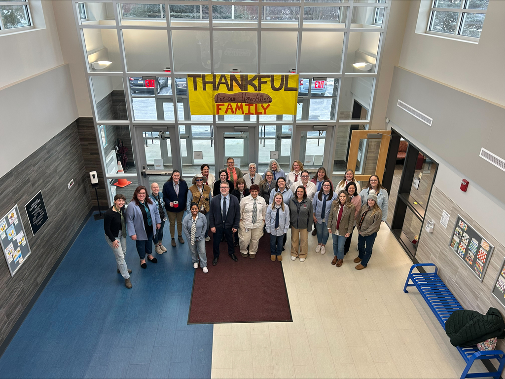 A group photo of staff dressed in matching shirts and ties.