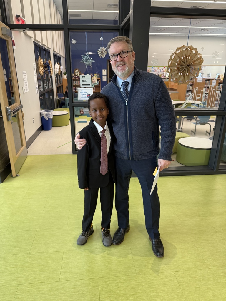 Students dressed in shirts and ties like their principal.