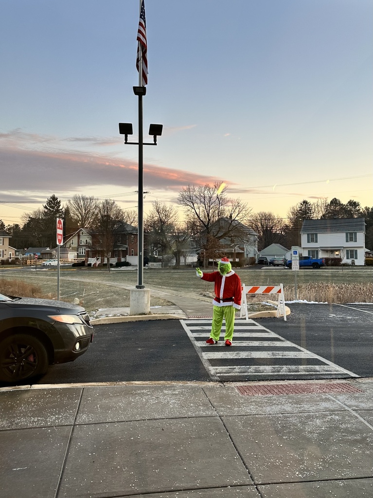 The Grinch directing traffic during school drop off.