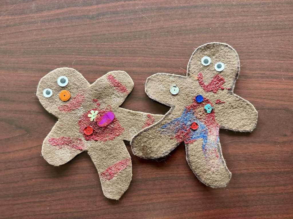 Two felt gingerbread men handmade by young students.