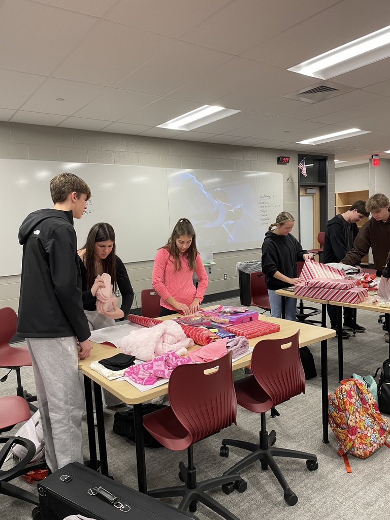 Students wrapping holiday gifts.