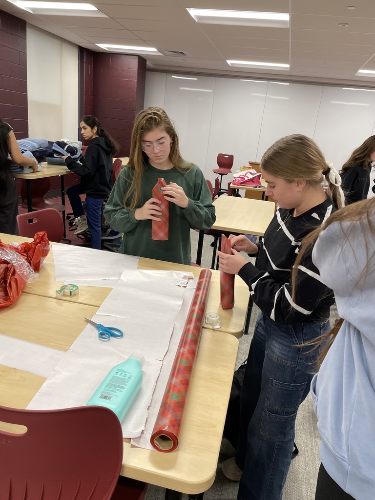 Students wrapping holiday gifts.