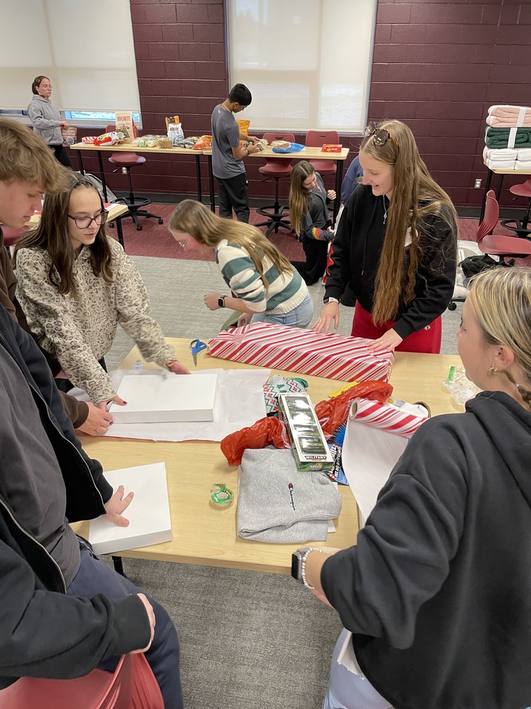 Students wrapping holiday gifts.