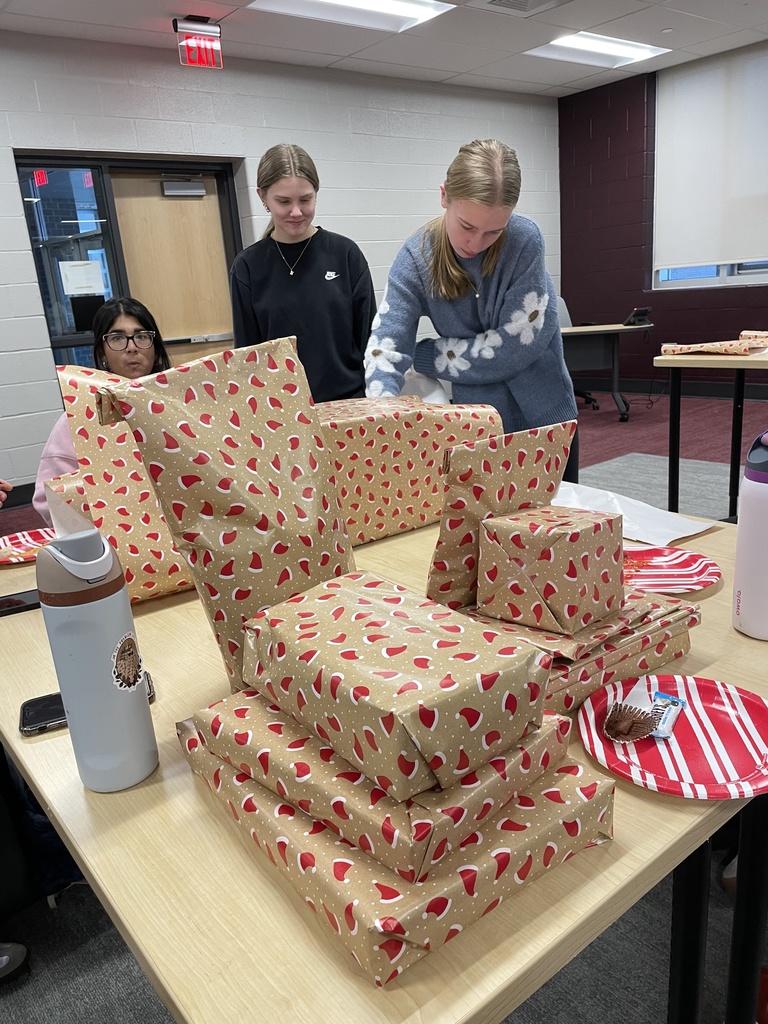 Students wrapping holiday gifts.