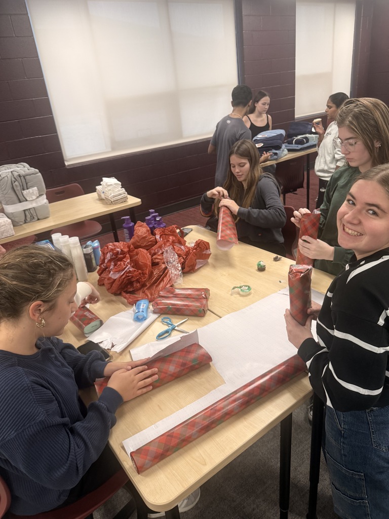 Students wrapping holiday gifts.