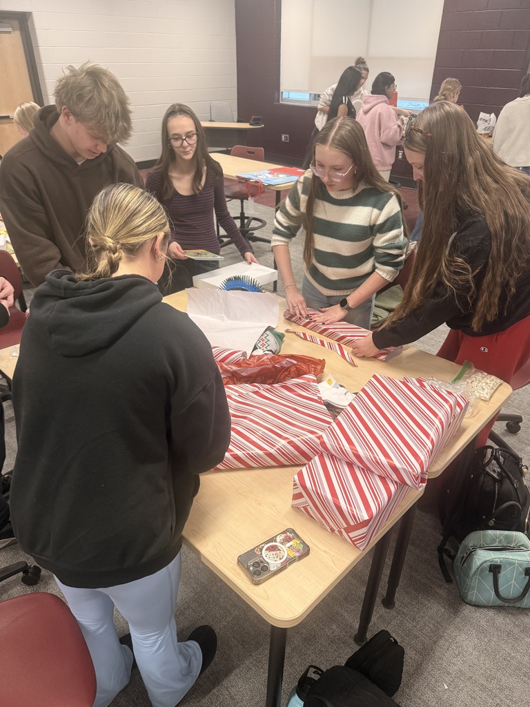 Students wrapping holiday gifts.