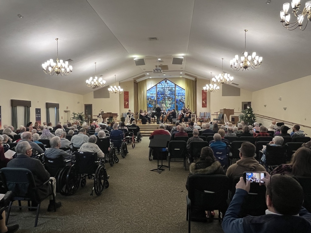 Student orchestra performance at a senior living community.