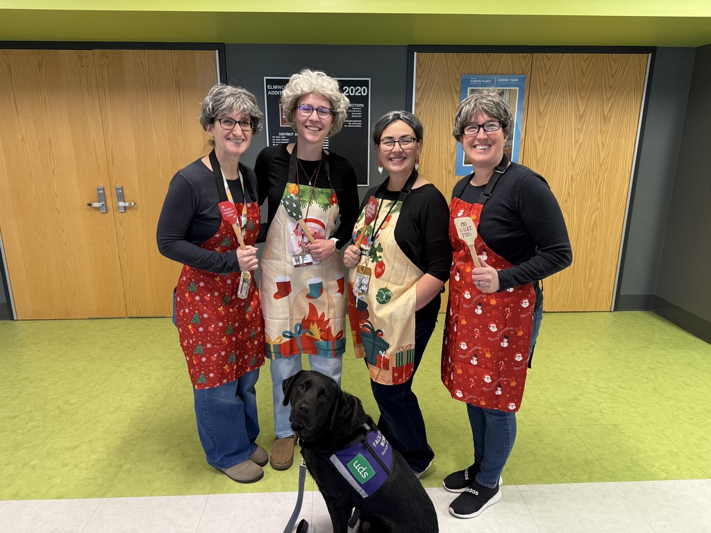 Staff dressed in colorful holiday aprons.
