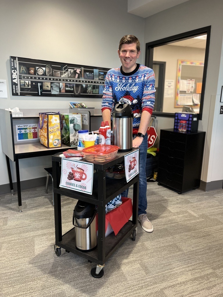 A principal delivers cocoa and cookies to staff.