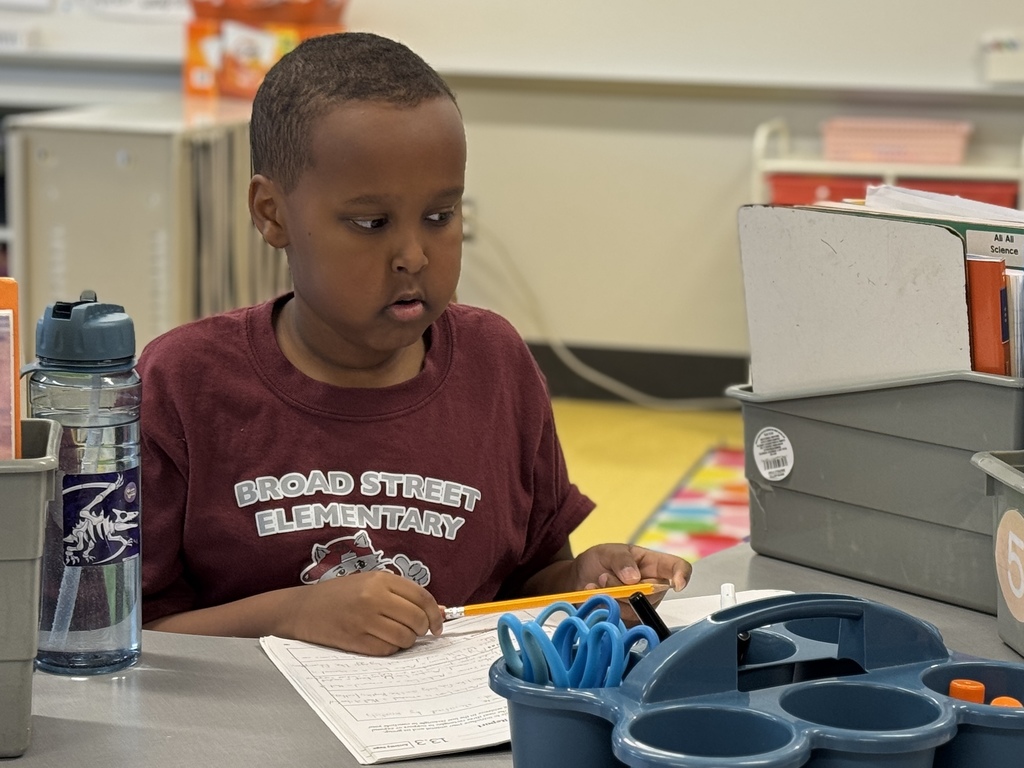 A student working at a school desk.