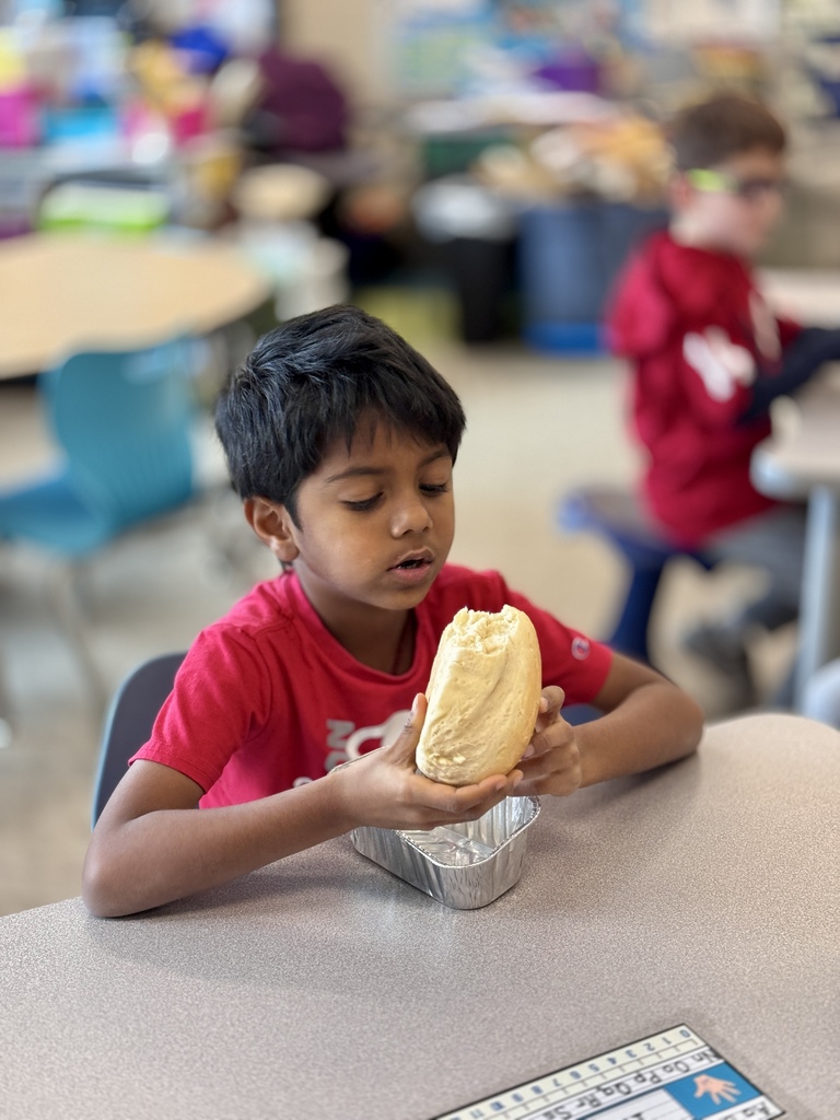 A young student enjoys a bite of homemade bread.