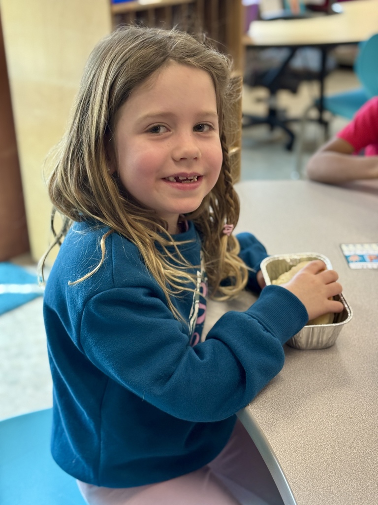 A young student enjoys a bite of homemade bread.