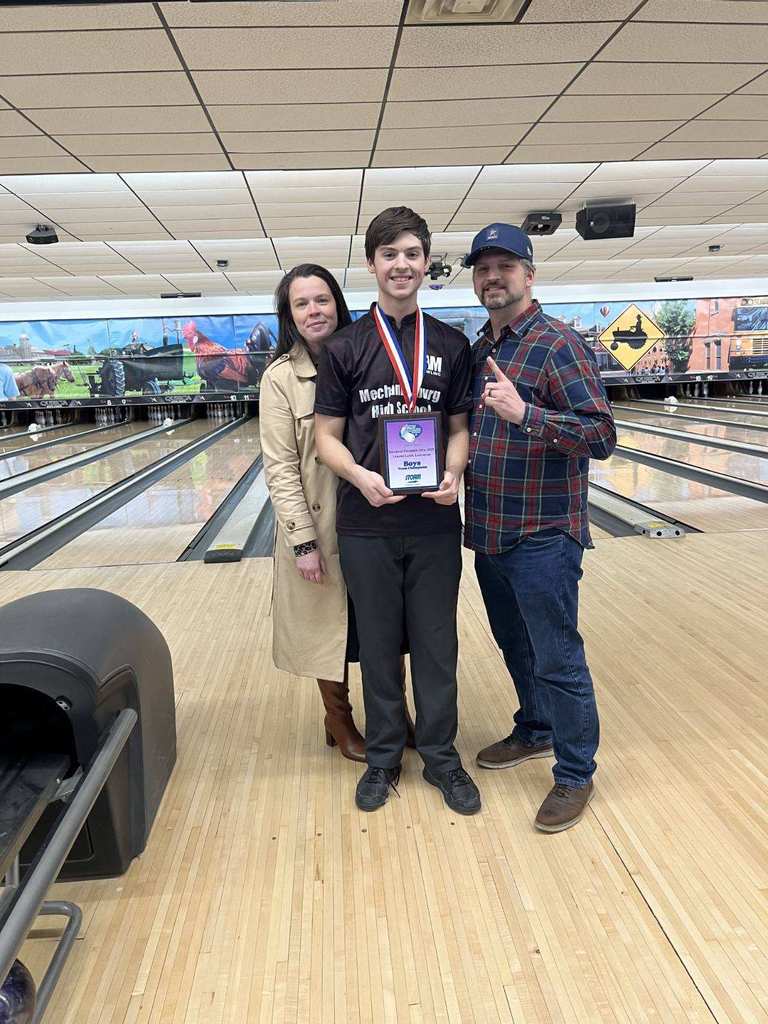 Bowler at bowling alley showing off championship medals.