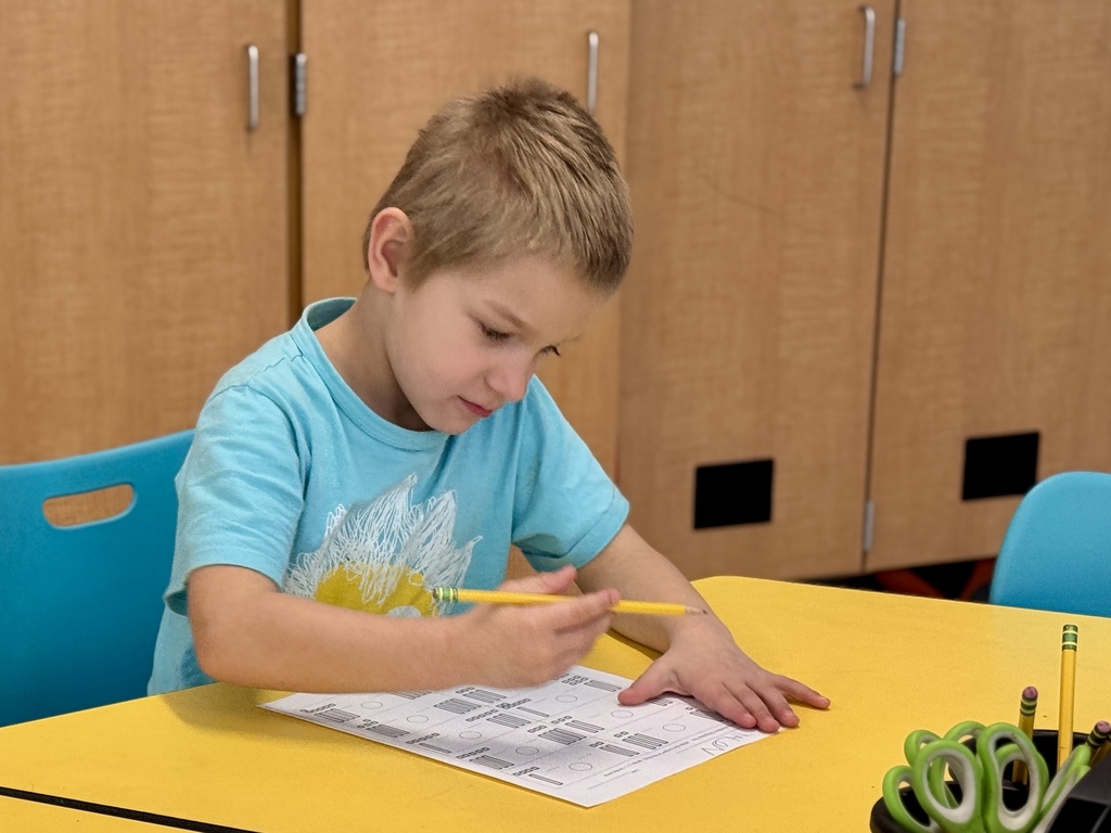 A student working on math at a desk.