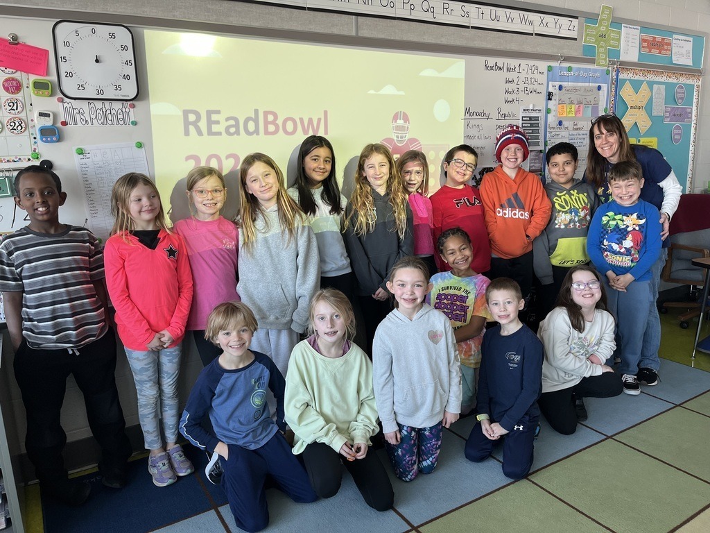 A group of students stand in front of a whiteboard that says READBowl 2026.