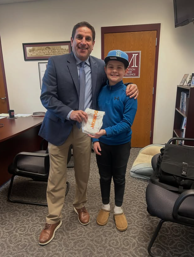 A student delivers Dunkin Donuts to a principal.