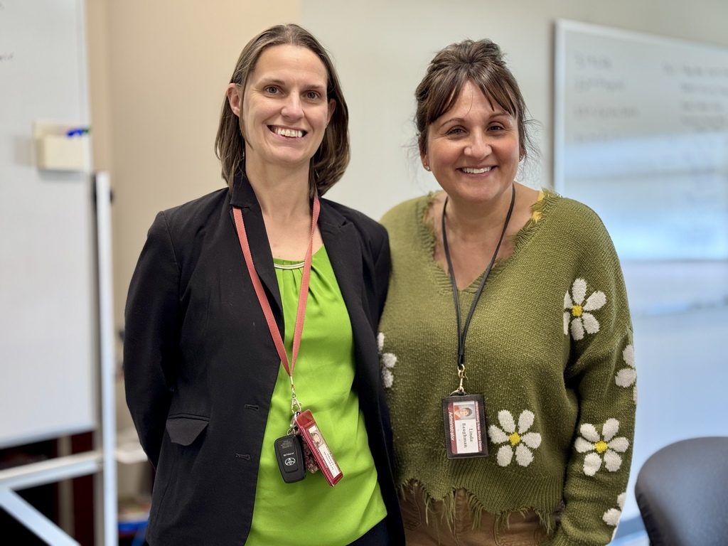 Two adult staff members wearing green for St. Patrick's Day.
