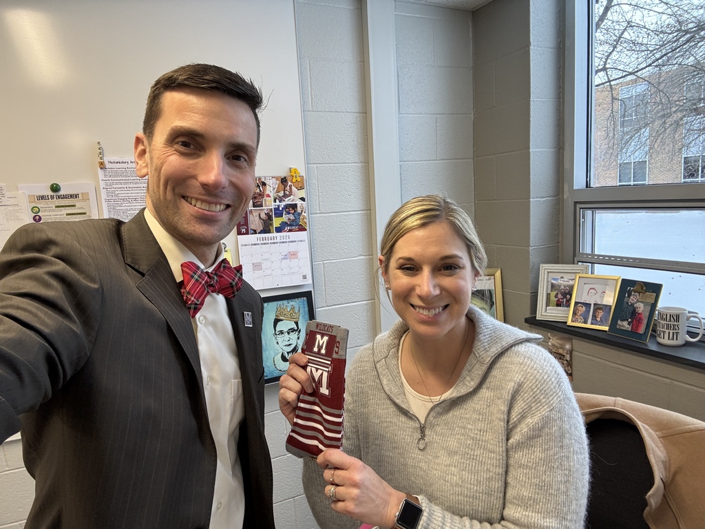 A man presenting a woman with a pair of branded socks.