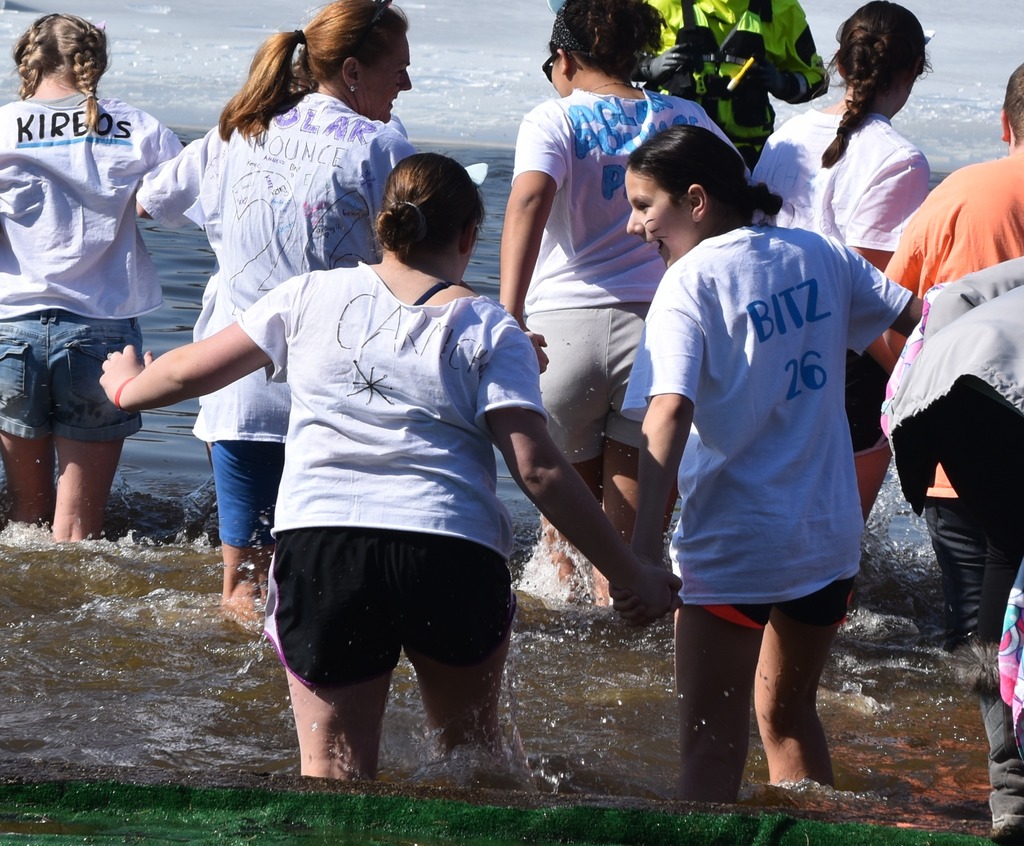 Students run into a frozen lake.