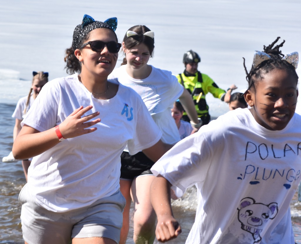 Students run out of a frozen lake.