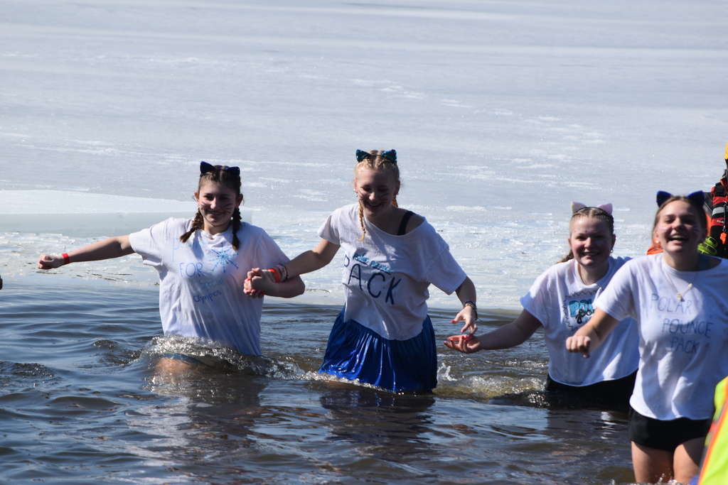 Students run out of a frozen lake.