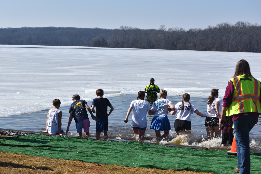Students run into a frozen lake.